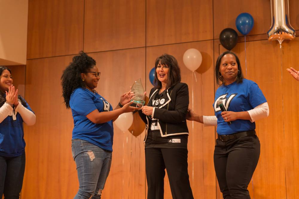 Image of President Mantella being presented with a gift by TRIO advisors for speaking at event